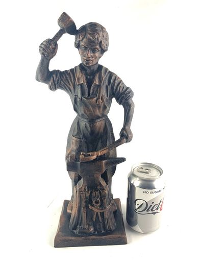 Vintage metal figurine of a blacksmith