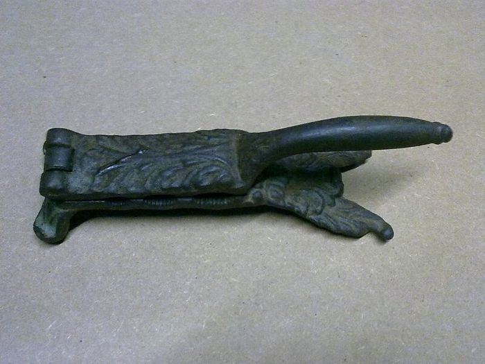 Old ornate cast iron cork presser