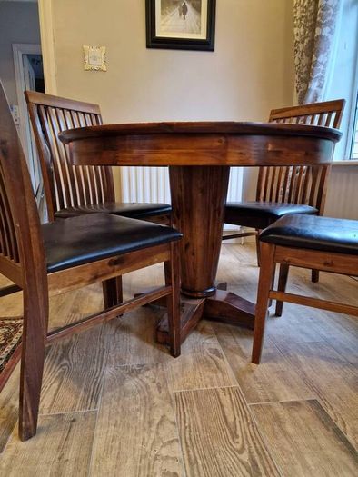 Round wooden table and four chairs