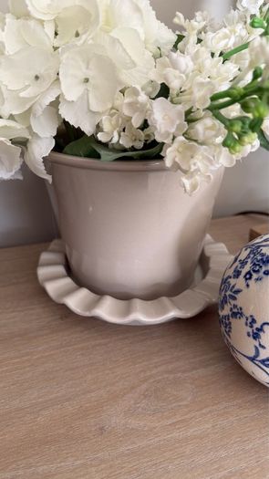 Beige pot with faux flowers