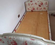 Timeless Elegance: Antique Bed with Floral Upholstery and Ornate Frame