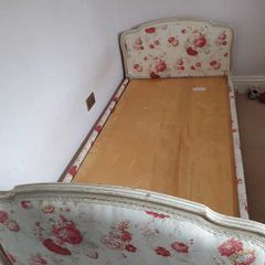 Timeless Elegance: Antique Bed with Floral Upholstery and Ornate Frame
