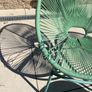 Marks & Spencer Lois garden furniture set in sage green, comprising two armchairs and a matching round table. Image 5