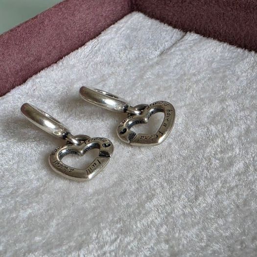 Pandora linked sister hearts split dangle charm. Very good condition hallmarked