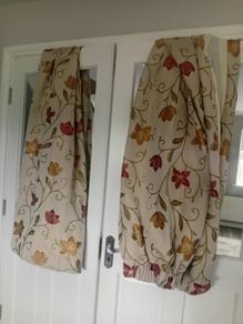 Red burnt orange flower print / cream curtains