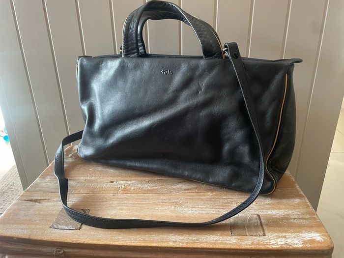 Tula black leather tote bag with a shoulder strap.