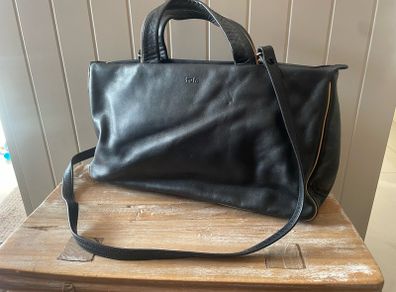 Tula black leather tote bag with a shoulder strap.