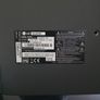 LG 42-inch Full HD Smart TV with a 3-tier black glass TV stand. Image 3