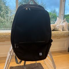 Black back pack, 3 pockets and a side net
