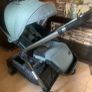 Sage green buggie with rain cover. Image 3