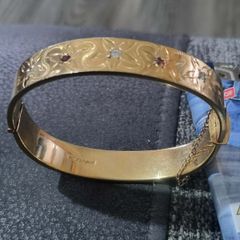 18 carat gold bangle plated over silver red and white stone