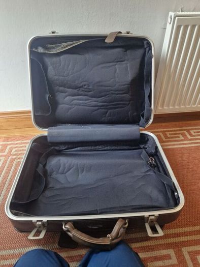 1leather suitcase and 1 faux leather suitcase.