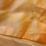 Solid orange satin look piece of fabric with beads Image 2