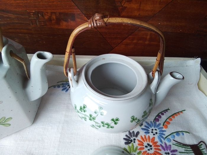 Two Wicker Handled Teapots