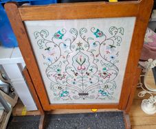 fire screen featuring a hand-embroidered floral needlepoint panel.