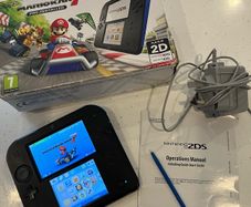 Nintendo 2ds with box and Mario kart game