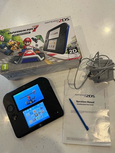 Nintendo 2ds with box and Mario kart game