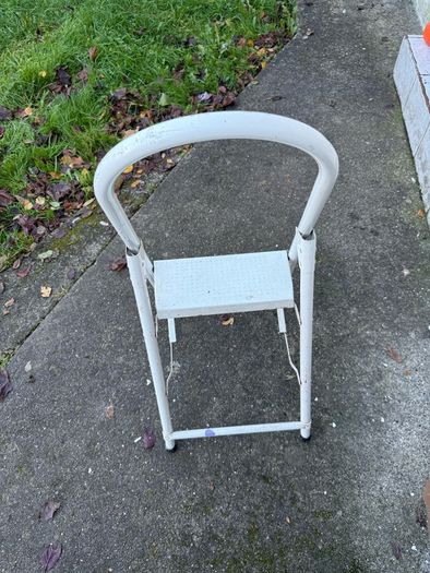 white metal 2-step folding household ladder with a high safety handrail.