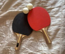 2 table tennis rackets and 2 balls