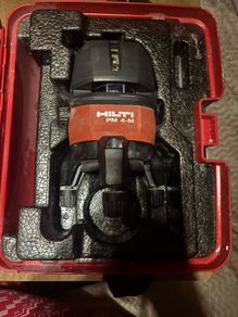 Hilti PM 4M Multi-Line Laser  Hilti PM 4M cordless multi-line laser with 360-degree rotation base, including the original red hardshell carry case.