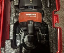 Hilti PM 4M Multi-Line Laser  Hilti PM 4M cordless multi-line laser with 360-degree rotation base, including the original red hardshell carry case.