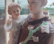 Antique Bisque Porcelain Statue of Saint Anthony holding Child Jesus.