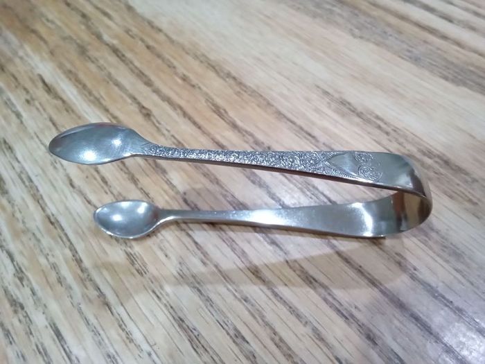 ornate silver sugar tongs