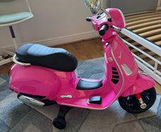 Vespa GTS Super electric scooter (powered by a 6V or 12V battery, with additional training wheels for stability)