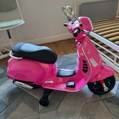 Vespa GTS Super electric scooter (powered by a 6V or 12V battery, with additional training wheels for stability)