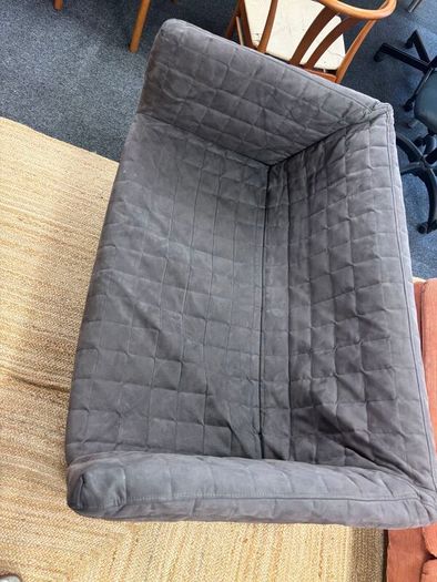 Grey quilted sofa with white metal frame