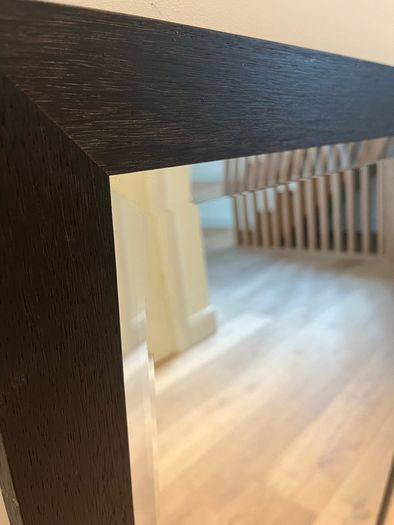 Black framed bevelled mirror