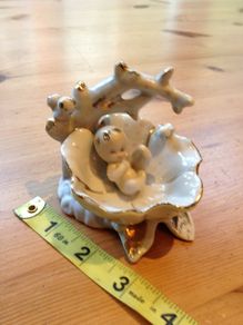 Beautiful porcelain baby in a flower