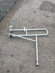 Drop down toilet grab bar