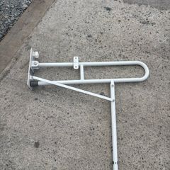 Drop down toilet grab bar