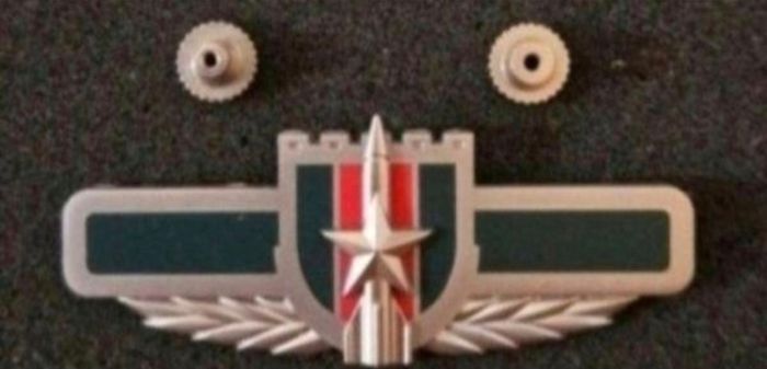China ,  peoples liberation army artillery badge.