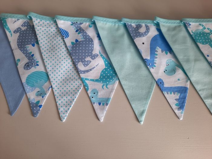 Dinosaur buntings . Blue and pink