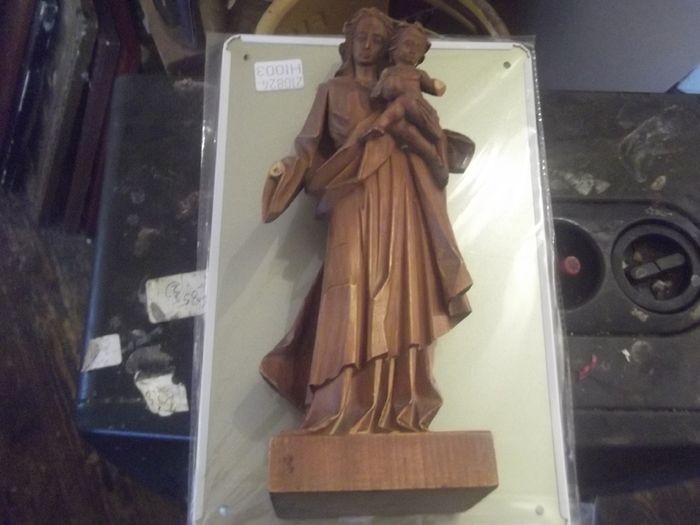a carved wooden holy figure