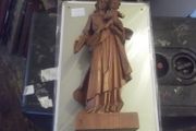 a carved wooden holy figure