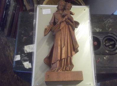 a carved wooden holy figure