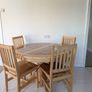 solid pine pedestal dining table with 4 matching four slatted wooden chairs. Image 2
