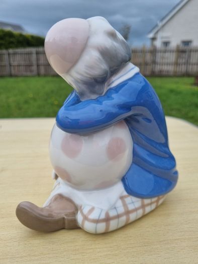 Porcelain sleeping clown with ball
