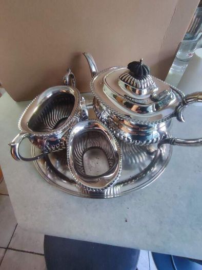 Vintage from the 19th century. Antique Period English Tea Service inc Teapot, Sugar bowl & milk jug Sheffield England on small silver plated tray.