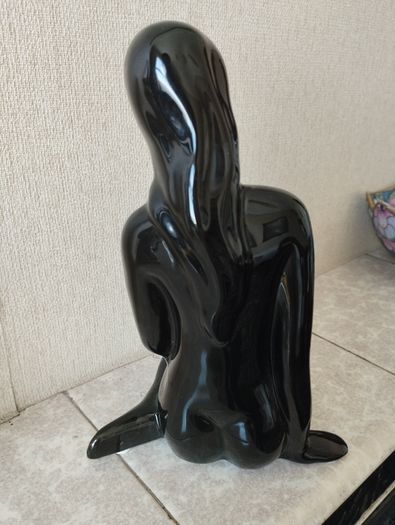 Vintage statue of a seated woman, nude figure, ceramic, glossy black.