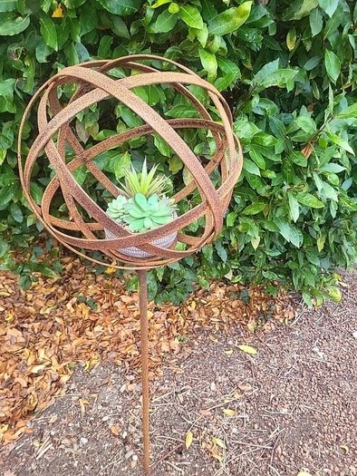 Corten steel garden sphere on a stem