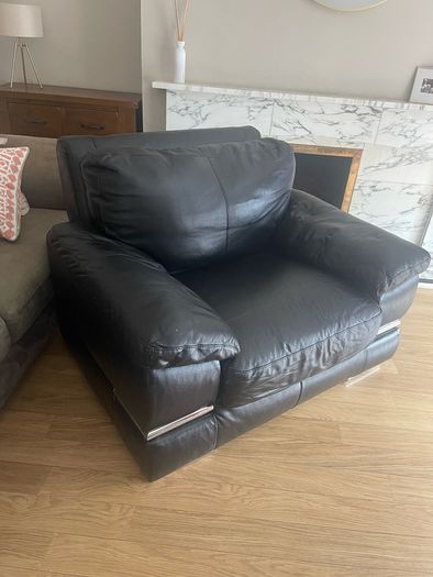 black Leather Armchair featuring plush pillow top arms and chrome accent feet need gone ASAP due to house clearance