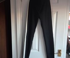Black skinny trousers featuring contrast white side stripes, size 8