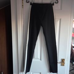 Black skinny trousers featuring contrast white side stripes, size 8