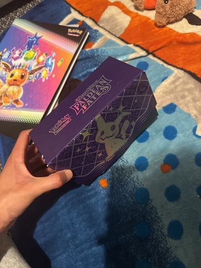 pokemon cards and book and sleeves and game thing