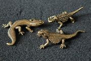 3 brass lizards.