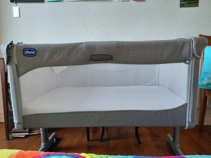 Next to me Chicco magic cot with snuz breatheble matress and bed sheets.